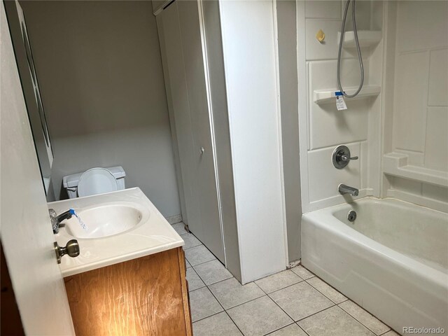 full bathroom featuring vanity, tile patterned floors, toilet, and shower / washtub combination