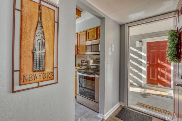 interior space featuring decorative backsplash and stainless steel appliances