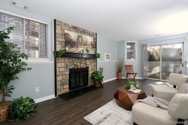 living room with a fireplace and dark wood-type flooring