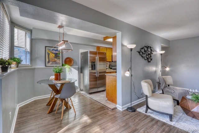 dining space with light hardwood / wood-style floors