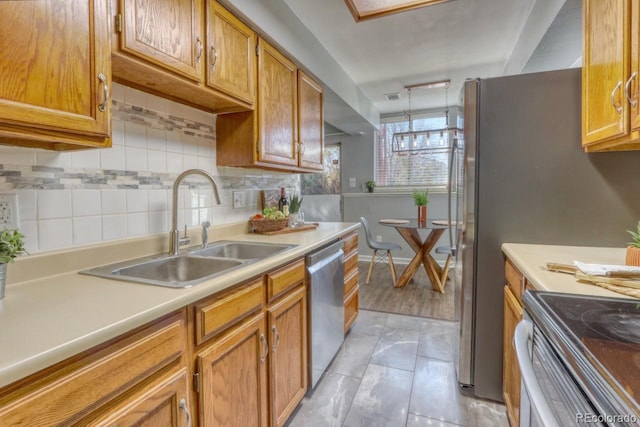 kitchen featuring tasteful backsplash, sink, light tile patterned flooring, and stainless steel dishwasher