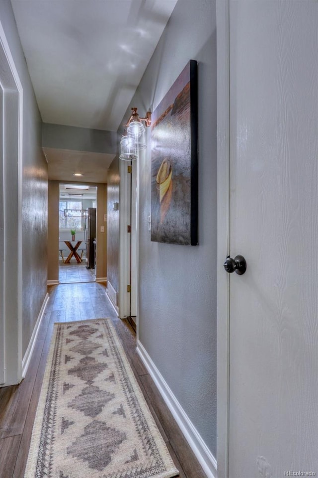 corridor with hardwood / wood-style floors