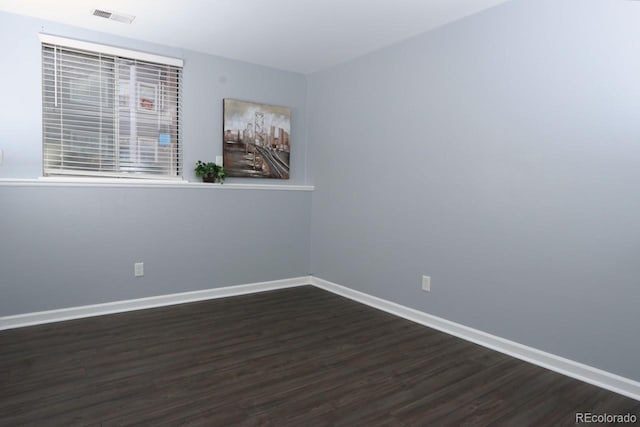 empty room featuring dark wood-type flooring