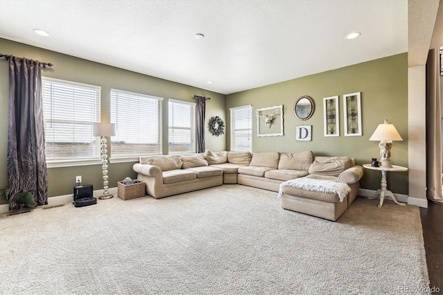 carpeted living room featuring a textured ceiling