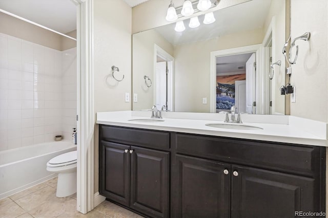 full bathroom featuring tiled shower / bath combo, vanity, tile patterned floors, and toilet