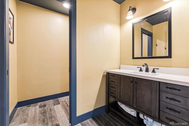 bathroom with vanity and wood-type flooring