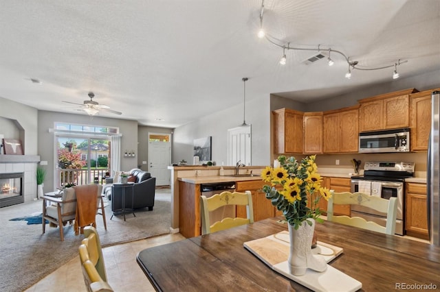 10818 Cimarron St Unit 1102, Firestone, CO 80504 - dining space featuring ceiling fan and a tiled fireplace