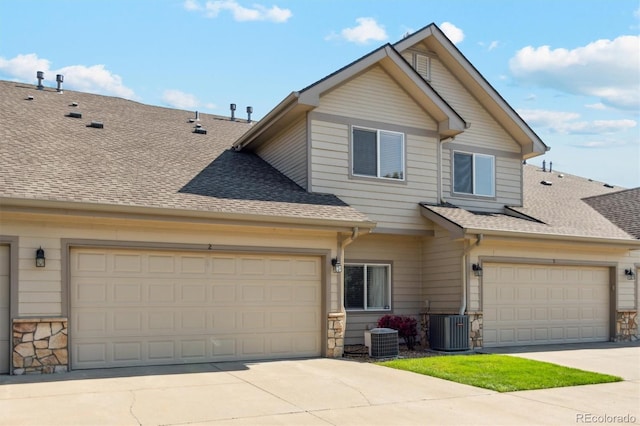 10818 Cimarron St Unit 1102, Firestone, CO 80504 - view of front facade featuring stone siding, a shingled roof, and driveway