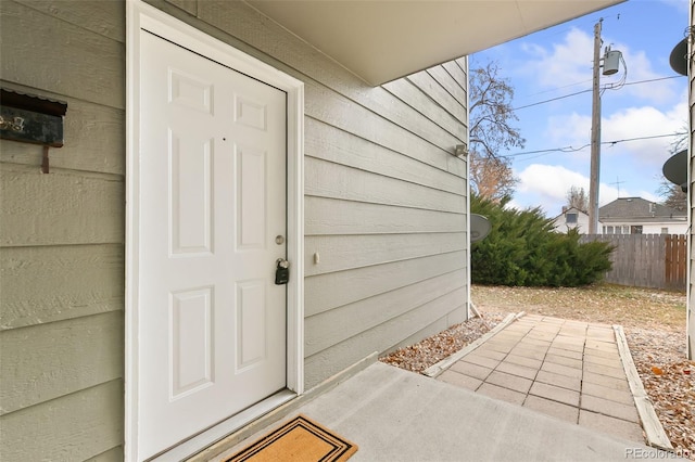 doorway to property with fence