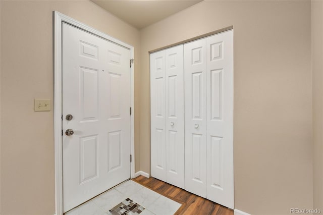 entryway with baseboards and light wood-style floors