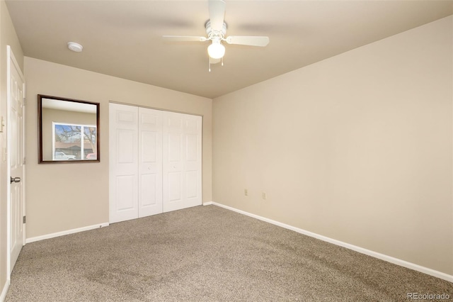 unfurnished bedroom with carpet, a closet, a ceiling fan, and baseboards