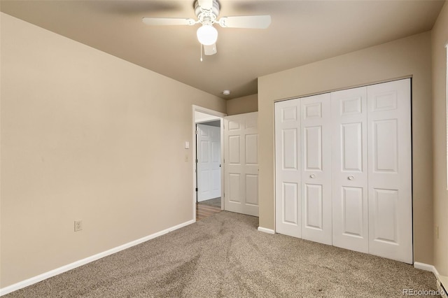 unfurnished bedroom featuring ceiling fan, baseboards, a closet, and carpet