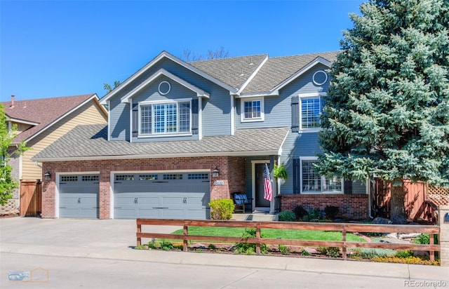 14533 W 69th Pl, Arvada, CO 80004 - view of front facade featuring brick siding, driveway, and a shingled roof