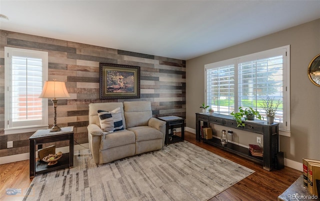 14533 W 69th Pl, Arvada, CO 80004 - living area with healthy amount of natural light, baseboards, wood finished floors, an accent wall, and wallpapered walls