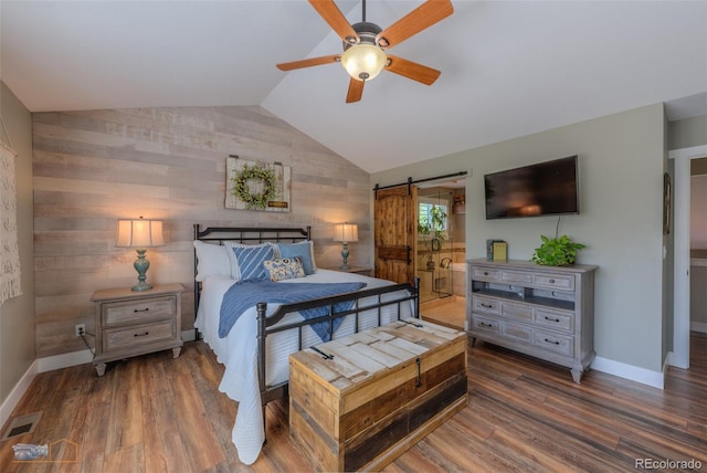 14533 W 69th Pl, Arvada, CO 80004 - bedroom with a barn door, wood finished floors, lofted ceiling, and baseboards