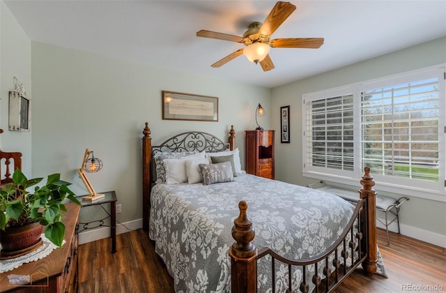 14533 W 69th Pl, Arvada, CO 80004 - bedroom with wood finished floors, baseboards, and a ceiling fan