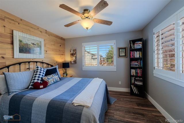 14533 W 69th Pl, Arvada, CO 80004 - bedroom with wooden walls, wood finished floors, baseboards, and ceiling fan