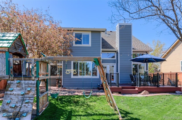 14533 W 69th Pl, Arvada, CO 80004 - rear view of house featuring a wooden deck, a yard, a chimney, and a shingled roof