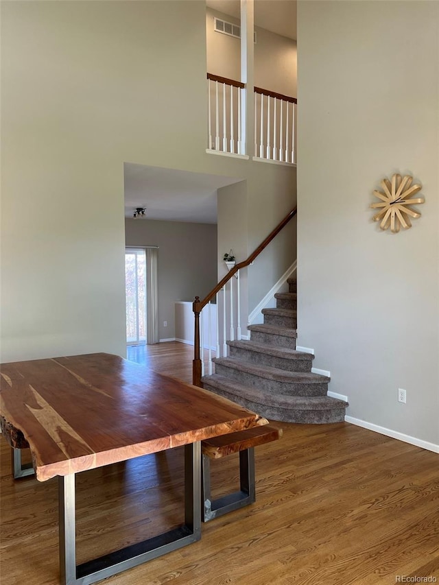 staircase with hardwood / wood-style floors