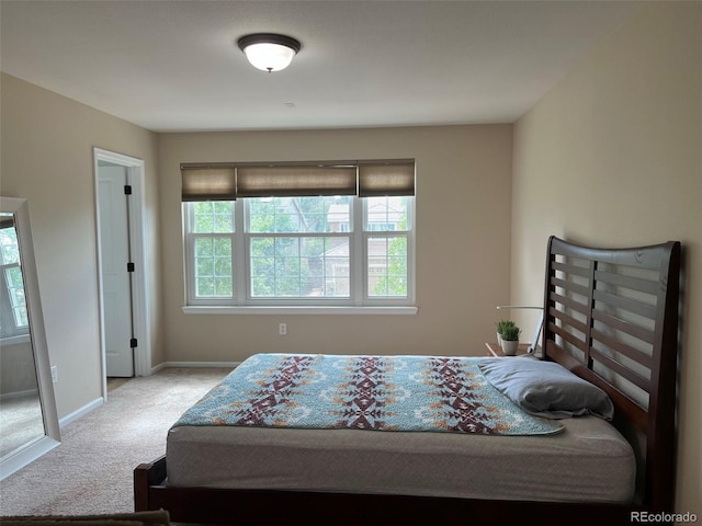 carpeted bedroom featuring multiple windows