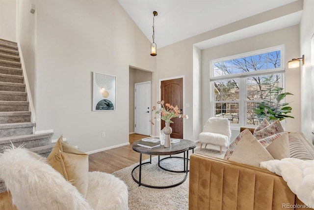 living room with hardwood / wood-style floors and high vaulted ceiling