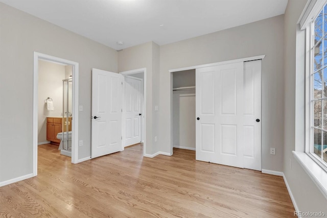 unfurnished bedroom with light hardwood / wood-style floors and a closet