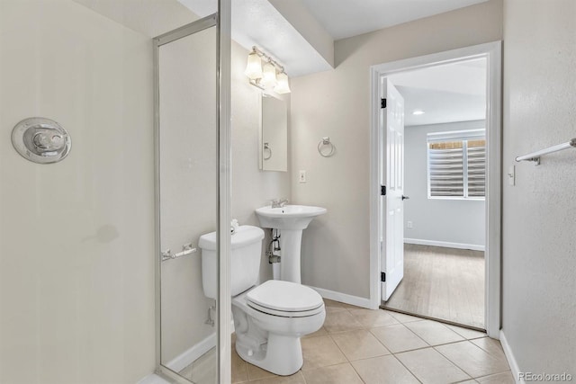 bathroom featuring tile patterned floors and toilet