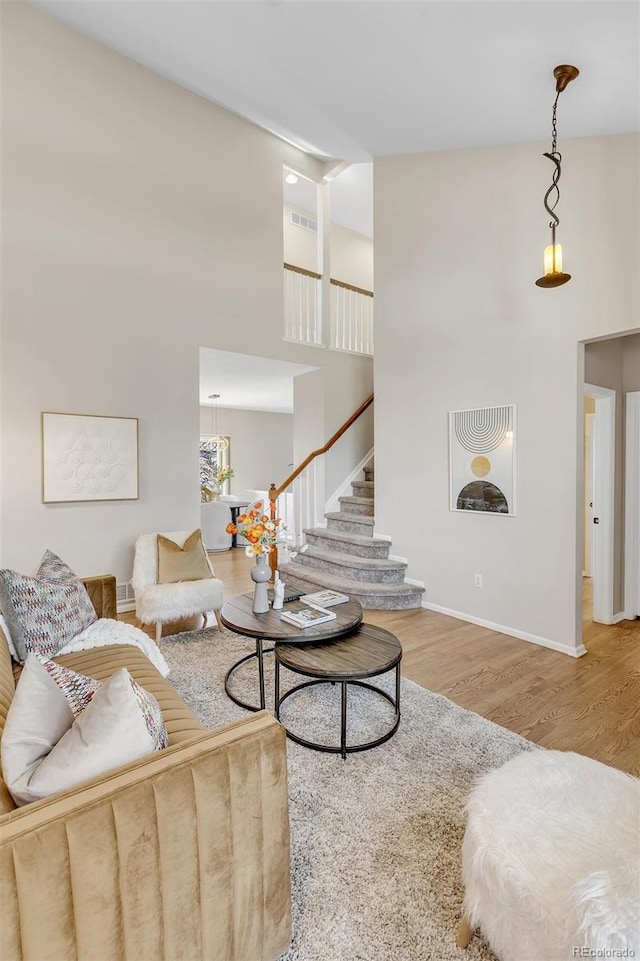 living room featuring hardwood / wood-style flooring and a high ceiling