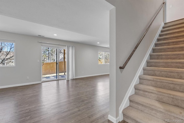 staircase with hardwood / wood-style floors