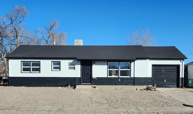 ranch-style house featuring concrete driveway and a garage