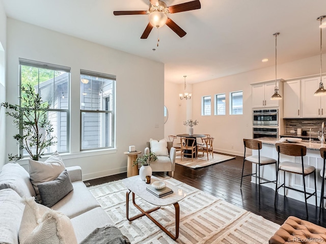 10479 E 25th Dr, Aurora, CO 80010 - living area featuring plenty of natural light, a chandelier, ceiling fan, dark wood-style floors, and recessed lighting