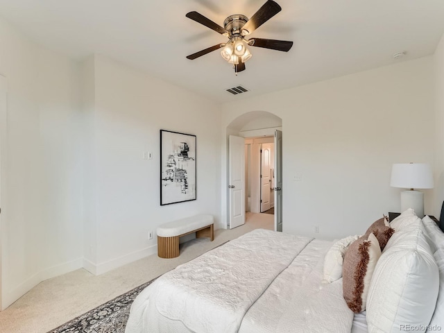 10479 E 25th Dr, Aurora, CO 80010 - bedroom featuring light colored carpet, arched walkways, and ceiling fan