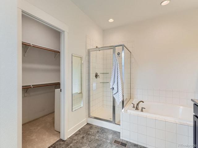10479 E 25th Dr, Aurora, CO 80010 - full bathroom featuring a shower stall, a garden tub, a spacious closet, and recessed lighting