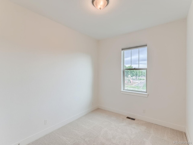 10479 E 25th Dr, Aurora, CO 80010 - spare room with light colored carpet and baseboards