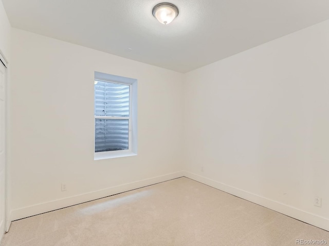 10479 E 25th Dr, Aurora, CO 80010 - spare room with baseboards and light colored carpet
