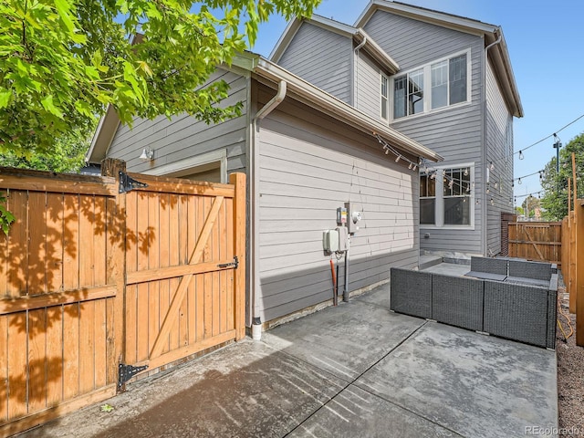10479 E 25th Dr, Aurora, CO 80010 - rear view of property featuring outdoor lounge area, a patio, a fenced backyard, and a gate
