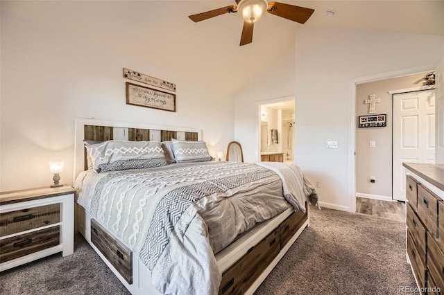 bedroom featuring dark colored carpet, ensuite bathroom, a ceiling fan, vaulted ceiling, and baseboards