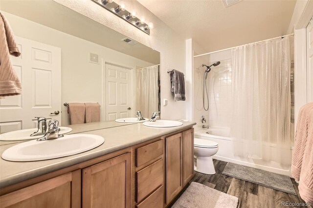 bathroom with shower / bath combination with curtain, a sink, and visible vents