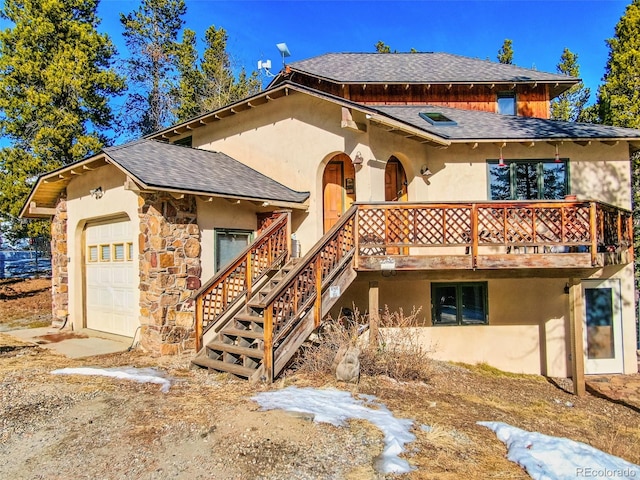 view of front of house with a garage and a deck