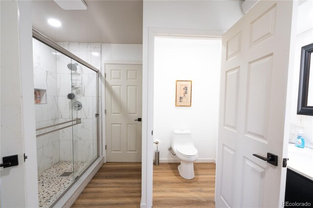 11865 Rangeview Cir, Salida, CO 81201 - bathroom featuring toilet, a stall shower, wood finished floors, vanity, and recessed lighting