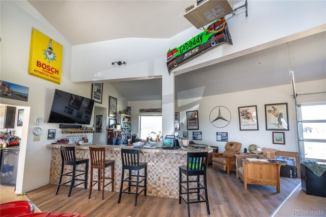 11865 Rangeview Cir, Salida, CO 81201 - kitchen with wood finished floors, lofted ceiling, healthy amount of natural light, a heating unit, and a kitchen bar
