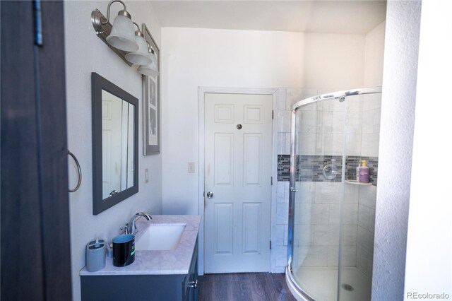11865 Rangeview Cir, Salida, CO 81201 - bathroom with vanity, a stall shower, and wood finished floors