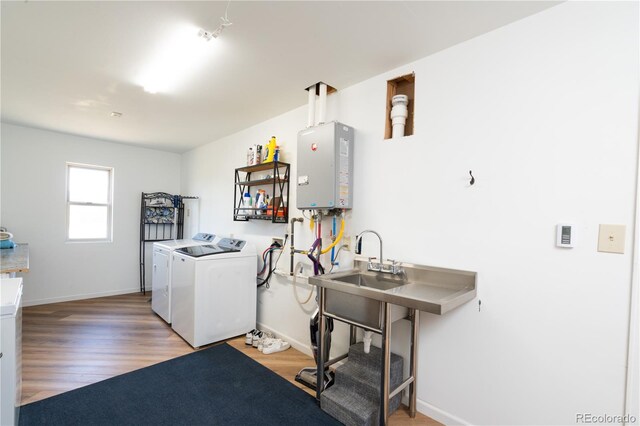 11865 Rangeview Cir, Salida, CO 81201 - washroom with separate washer and dryer, light wood finished floors, baseboards, and tankless water heater