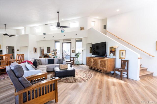 11865 Rangeview Cir, Salida, CO 81201 - living room featuring a ceiling fan, stairway, recessed lighting, light wood-type flooring, and a high ceiling