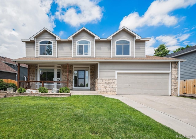 5573 S Taft St, Littleton, CO 80127 - traditional home with covered porch, concrete driveway, stone siding, and a garage