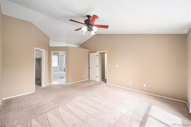 5573 S Taft St, Littleton, CO 80127 - unfurnished bedroom with light carpet, lofted ceiling, a walk in closet, ensuite bath, and baseboards