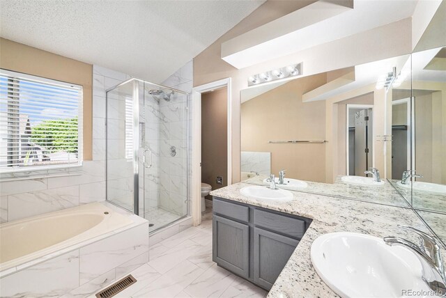 5573 S Taft St, Littleton, CO 80127 - bathroom featuring a shower stall, a garden tub, double vanity, lofted ceiling, and toilet