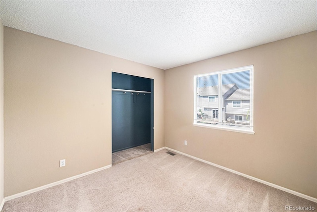 5573 S Taft St, Littleton, CO 80127 - unfurnished bedroom with carpet, a closet, baseboards, and a textured ceiling