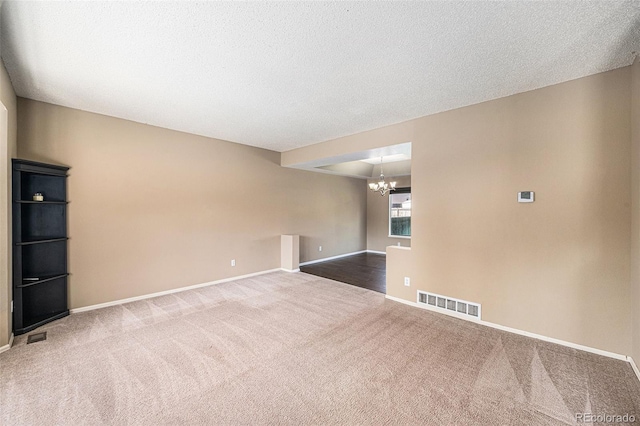 5573 S Taft St, Littleton, CO 80127 - carpeted empty room featuring a chandelier, baseboards, and a textured ceiling