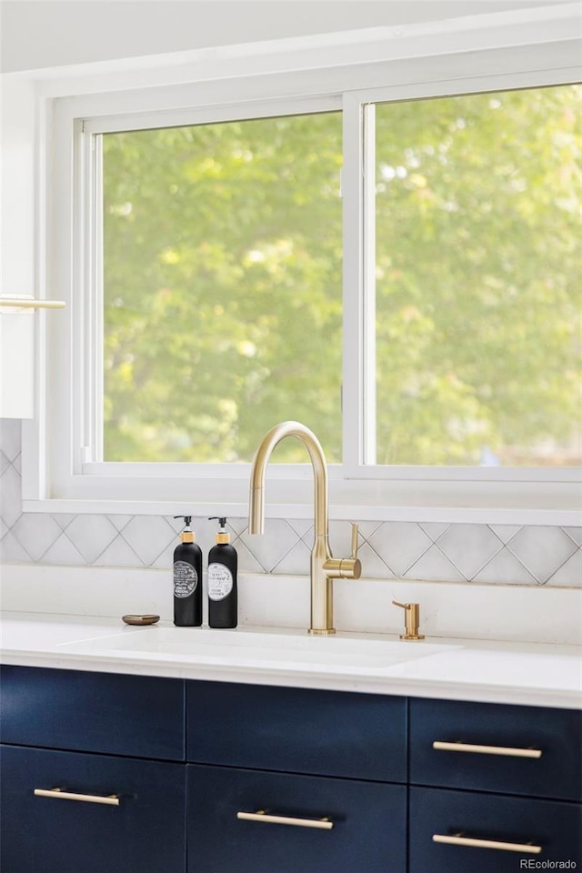 4421 Raleigh St, Denver, CO 80212 - detailed view of blue cabinets, tasteful backsplash, and light countertops
